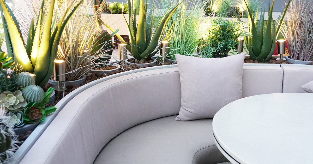 Curved outdoor furniture surrounded by succulent garden